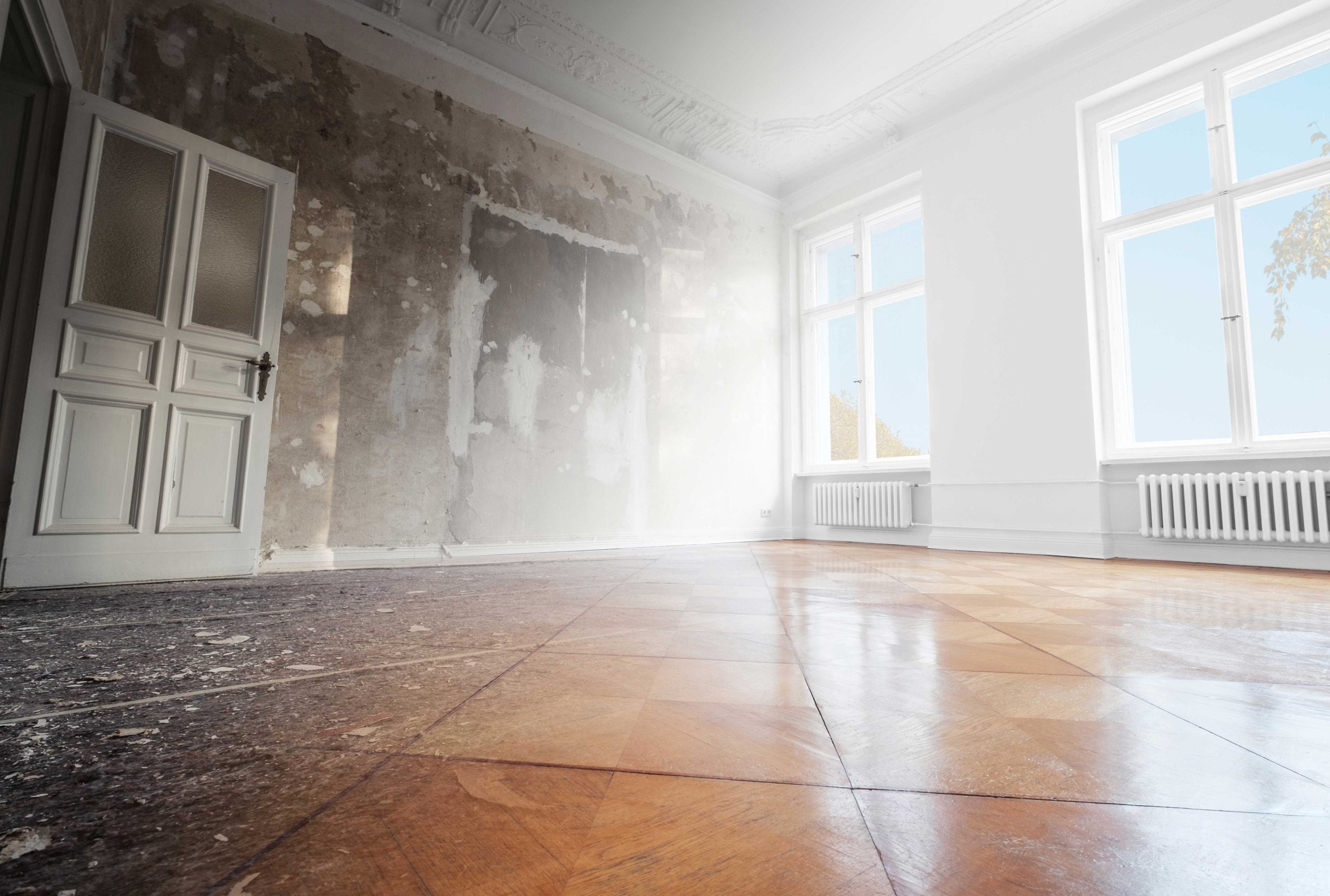 Smoke damage affects the wall and floor of a room in a {city} home.